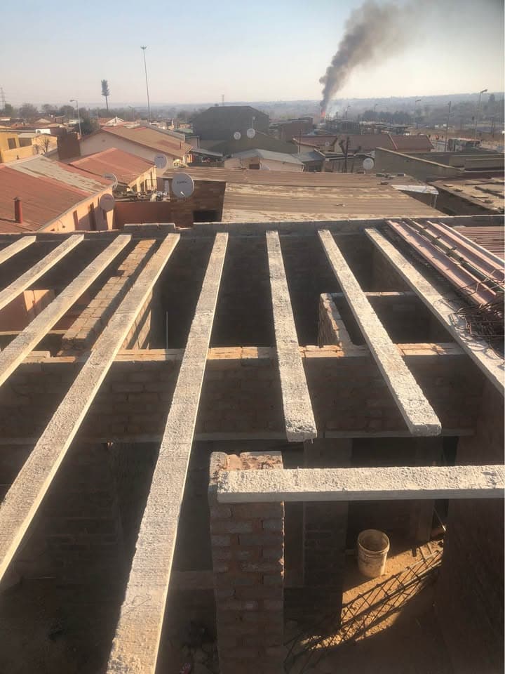 Roof slab beams installed across a residential structure